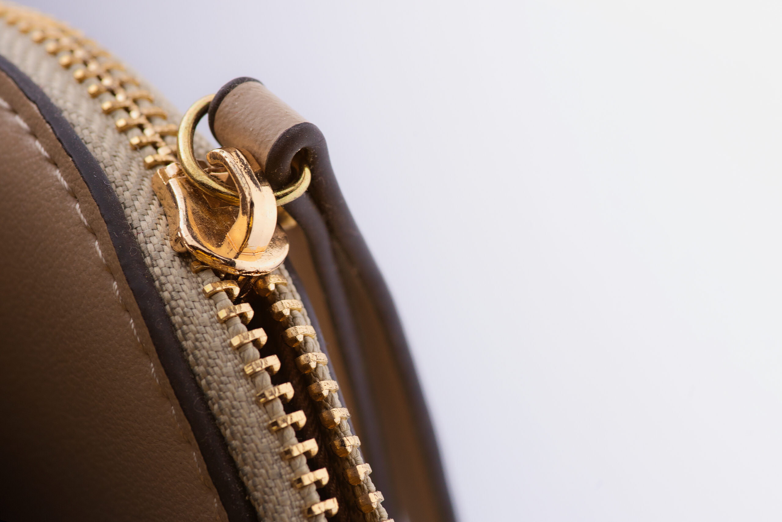 Close-up of handbag zip and metal hardware