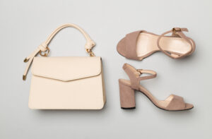Designer leather bag styled on colour background