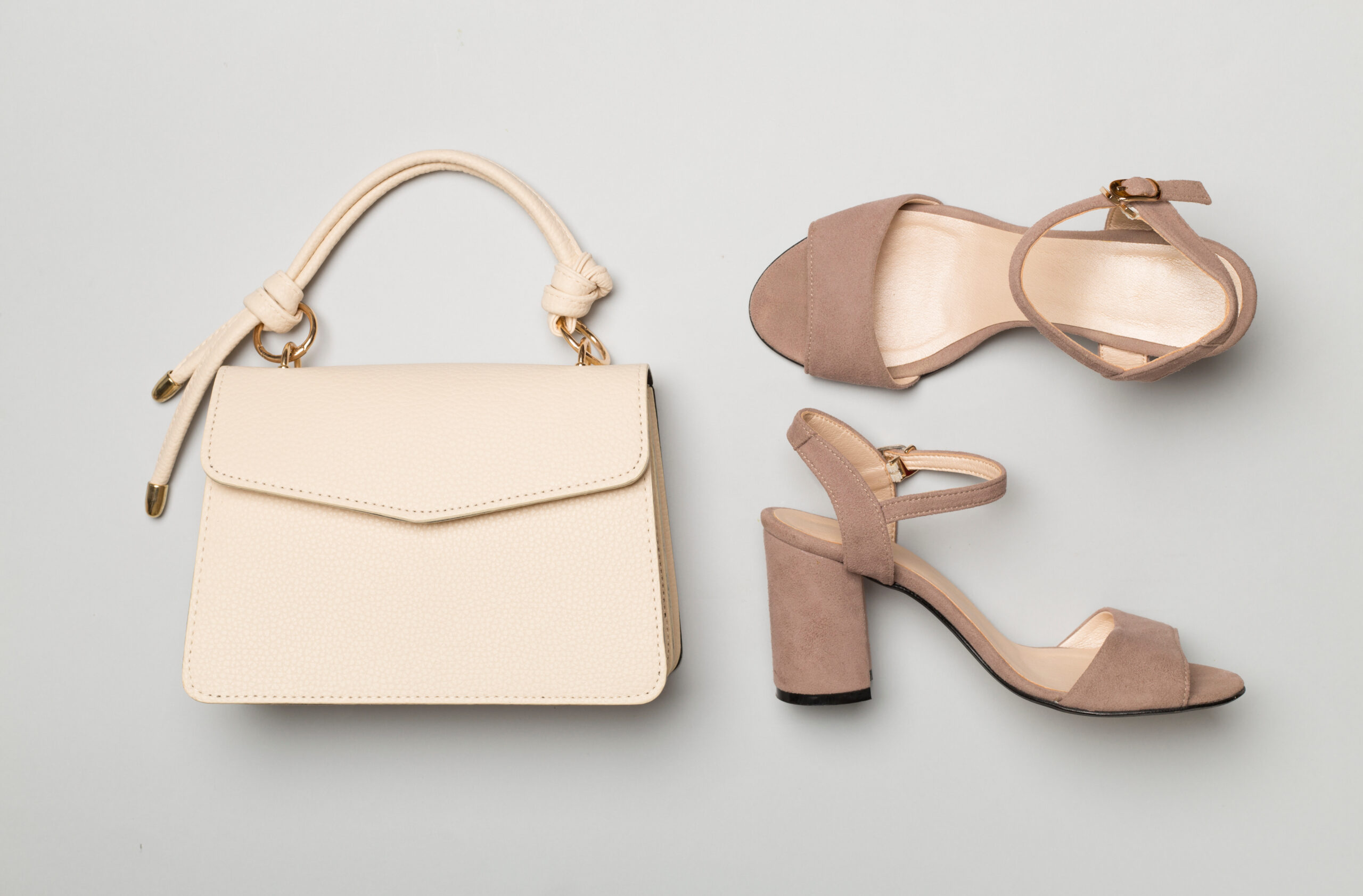 Designer leather bag styled on colour background