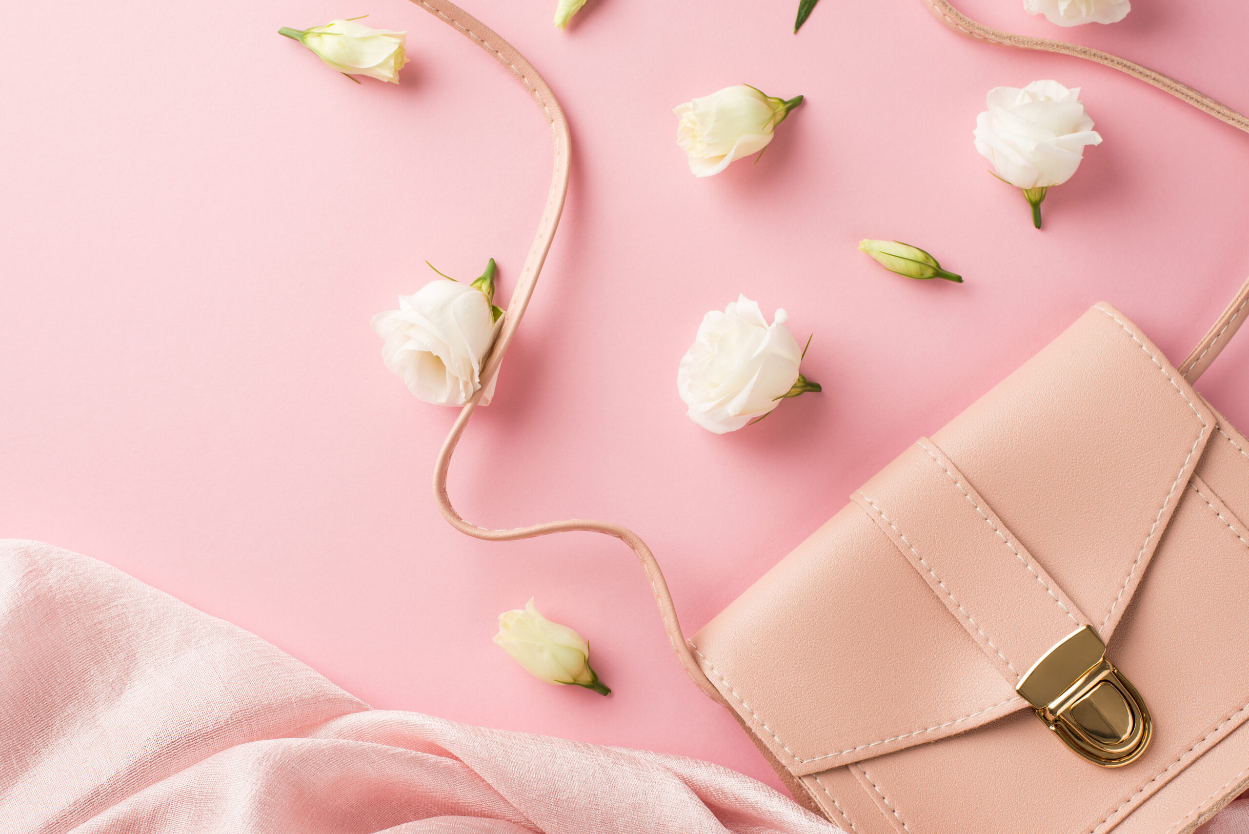 Pink leather handbag styled flat lay